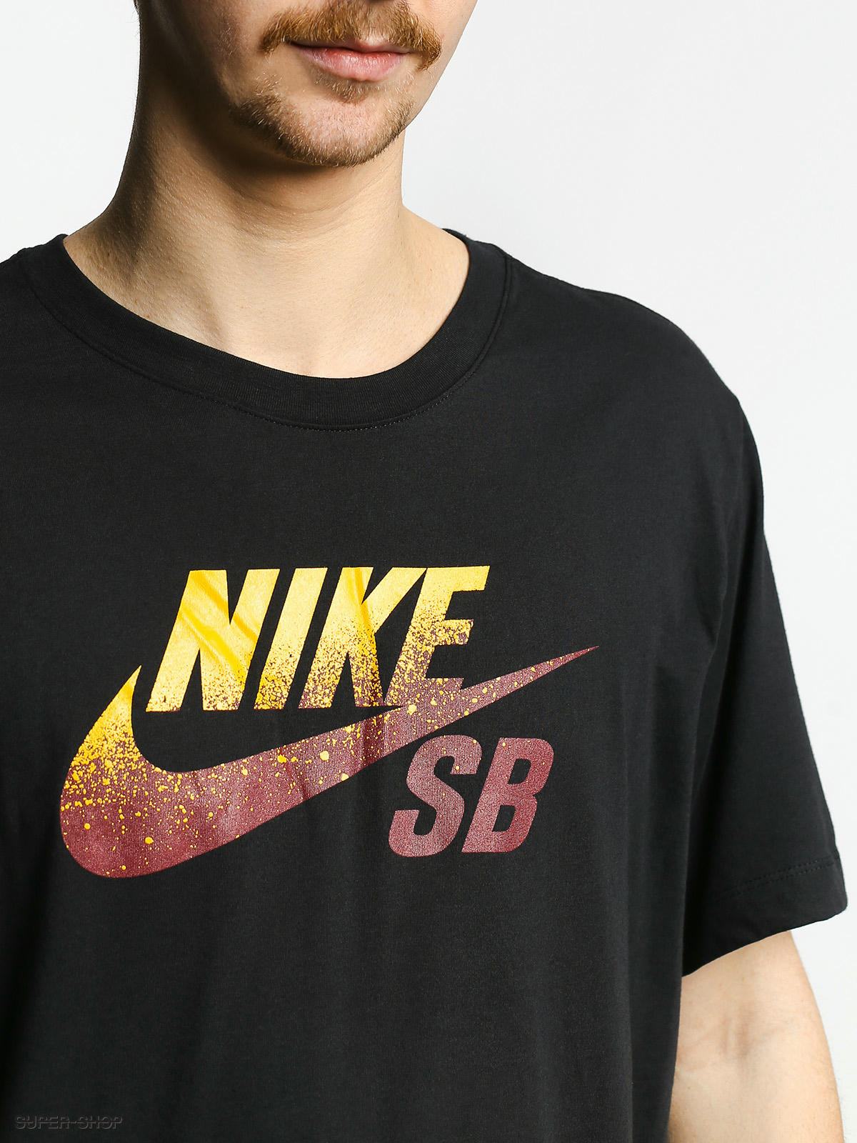 red black and gold nike shirt