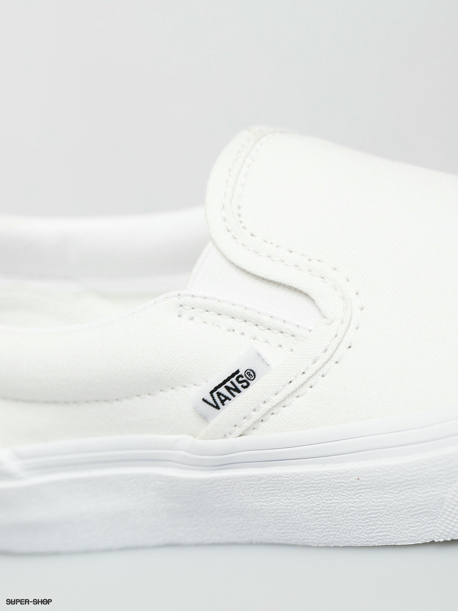 White slip on vans junior sale