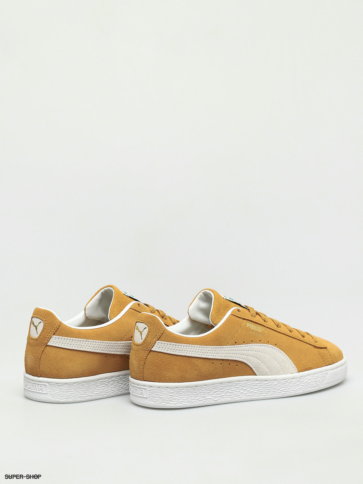 brown and white puma shoes