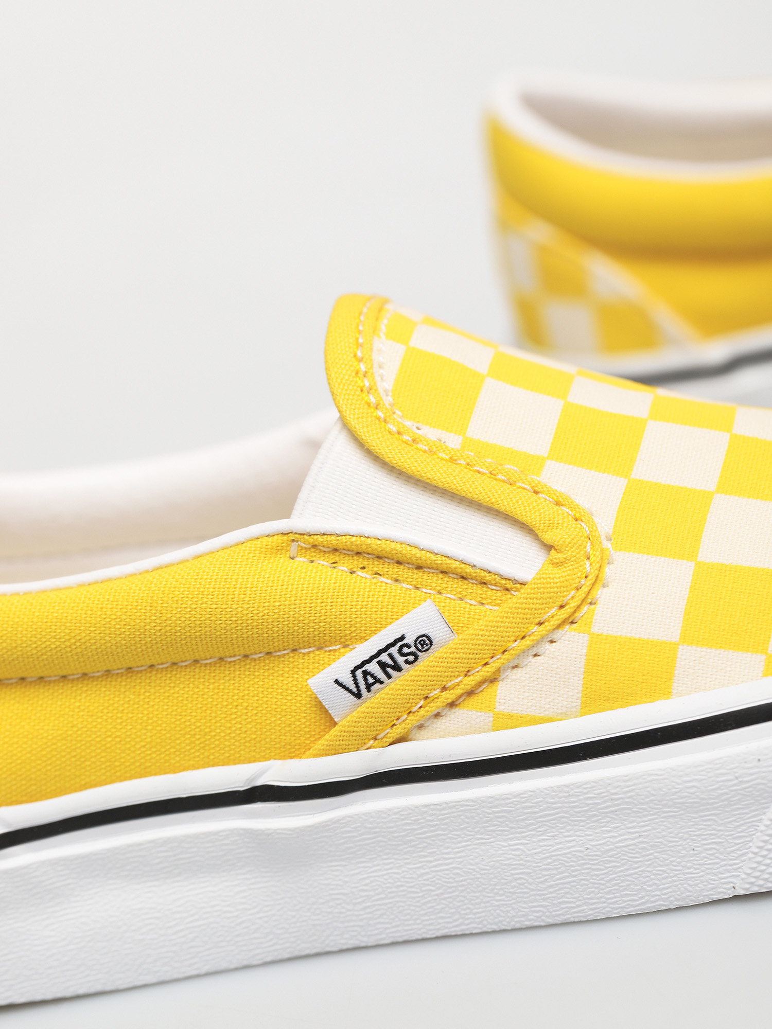 yellow and white vans slip on