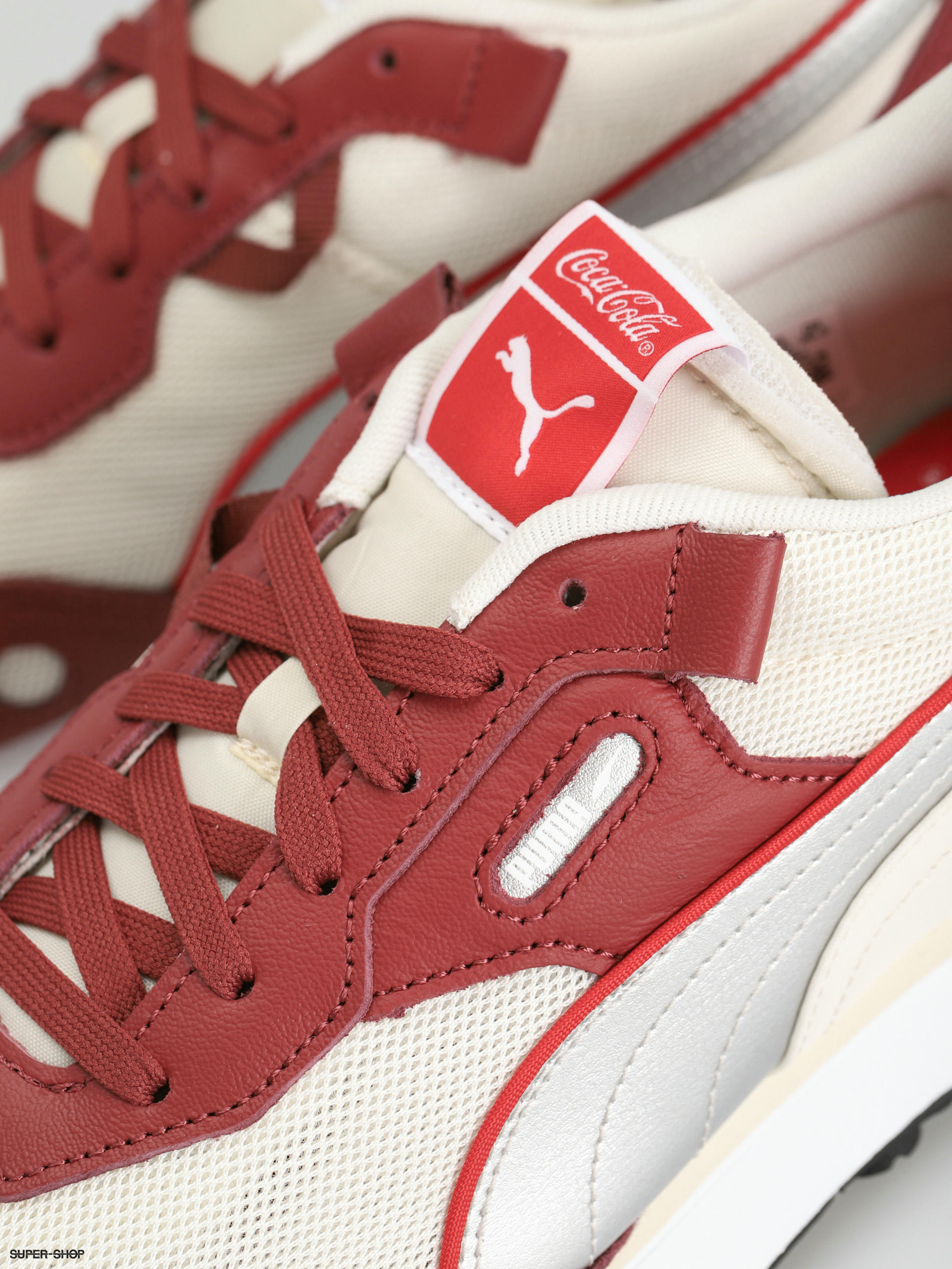 white pumas with red stripe